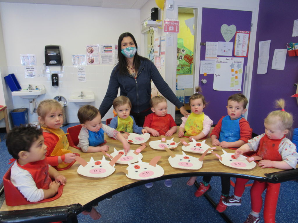 teacher at casa with her young students showing their ox decorations for the lunar new year