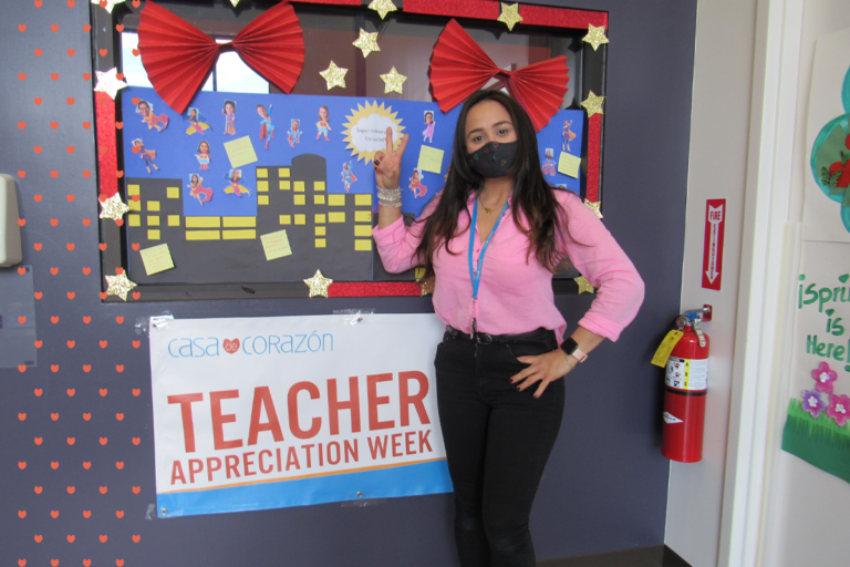 casa teacher standing in front of a banner reading teacher appreciation week