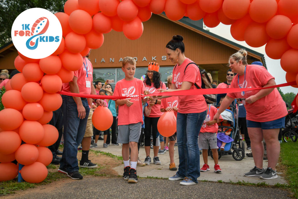 cutting the ribbon at our 1K for kids walk