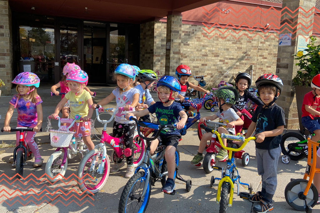 trike-a-thon week at casa, kids with bikes in front of one of our centers