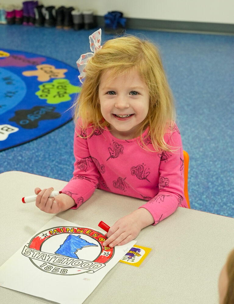 Pre-K child doing a craft project to help with the development of fine motor skills as a part of kindergarten readiness